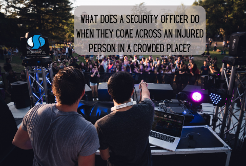 What does a security officer do when they come across an injured person in a crowded place